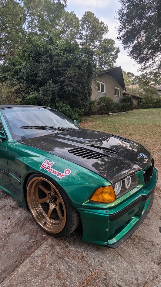 Green BMW E36 paint and carbon-fiber hood detail
