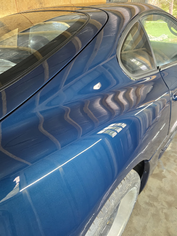 Reflections across the roof and rear quarter