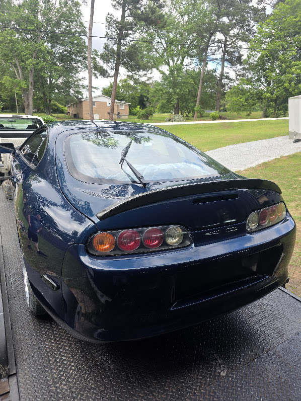 Blue Toyota Supra with refinished rear bodywork and carbon-fiber spoiler