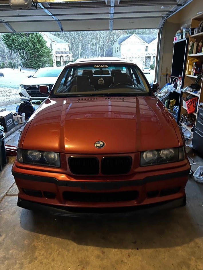 Red E36 paint and bumper under garage lighting