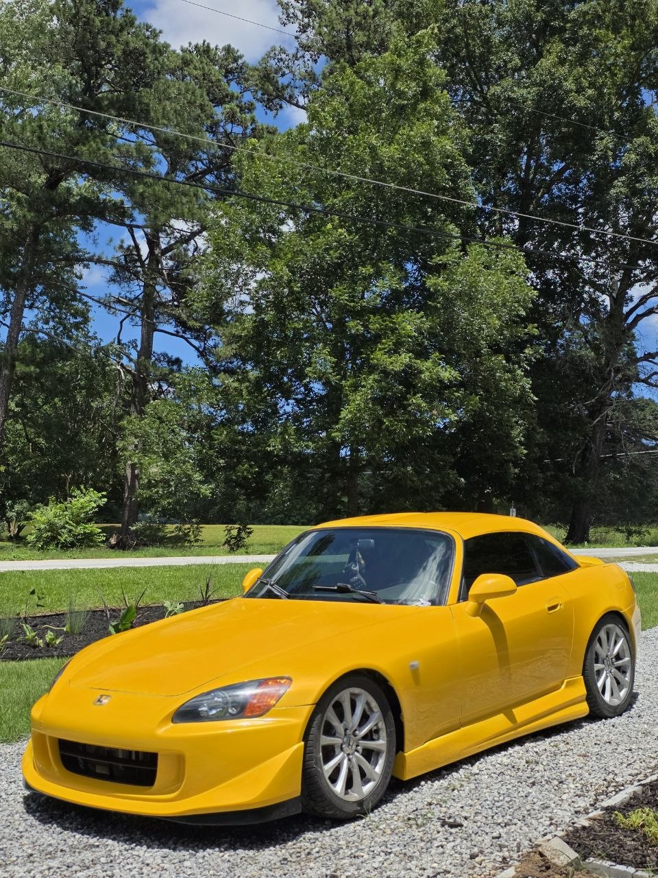 Candy Yellow Honda S2000 with its finished paint in daylight